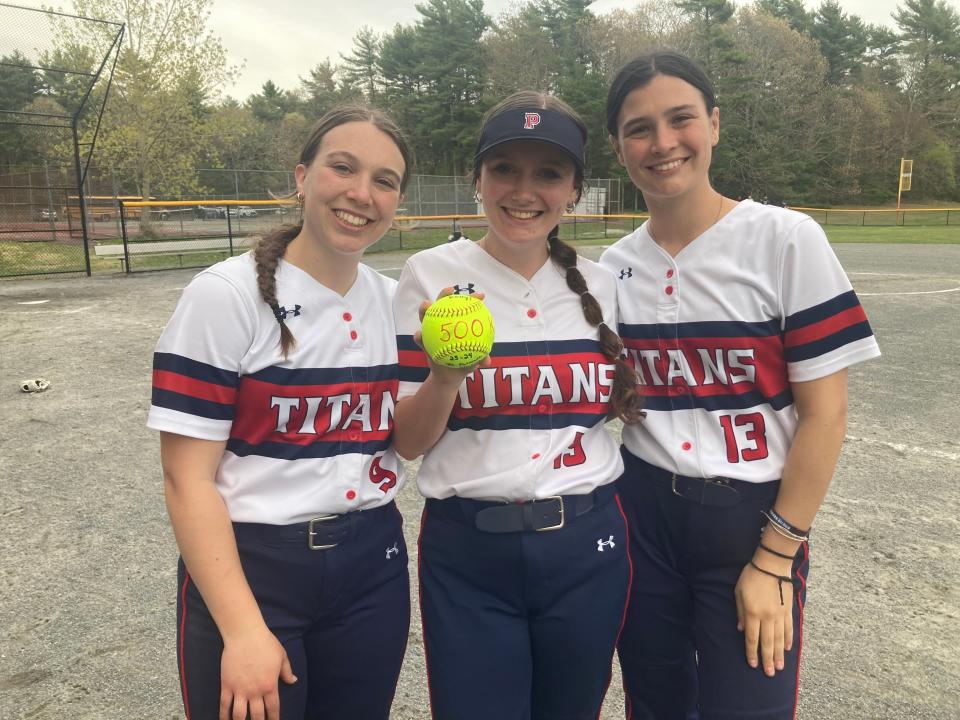 Pembroke’s Kelly McGee (center) celebrates with teammates Ava Dunphy (left) and Maria Cantino (right) after reaching 500 career strikeouts in a 6-0 win over Falmouth on Monday, May 6, 2024. McGee threw a 2-hitter with 11 Ks as the Titans (10-3) clinched a playoff berth.