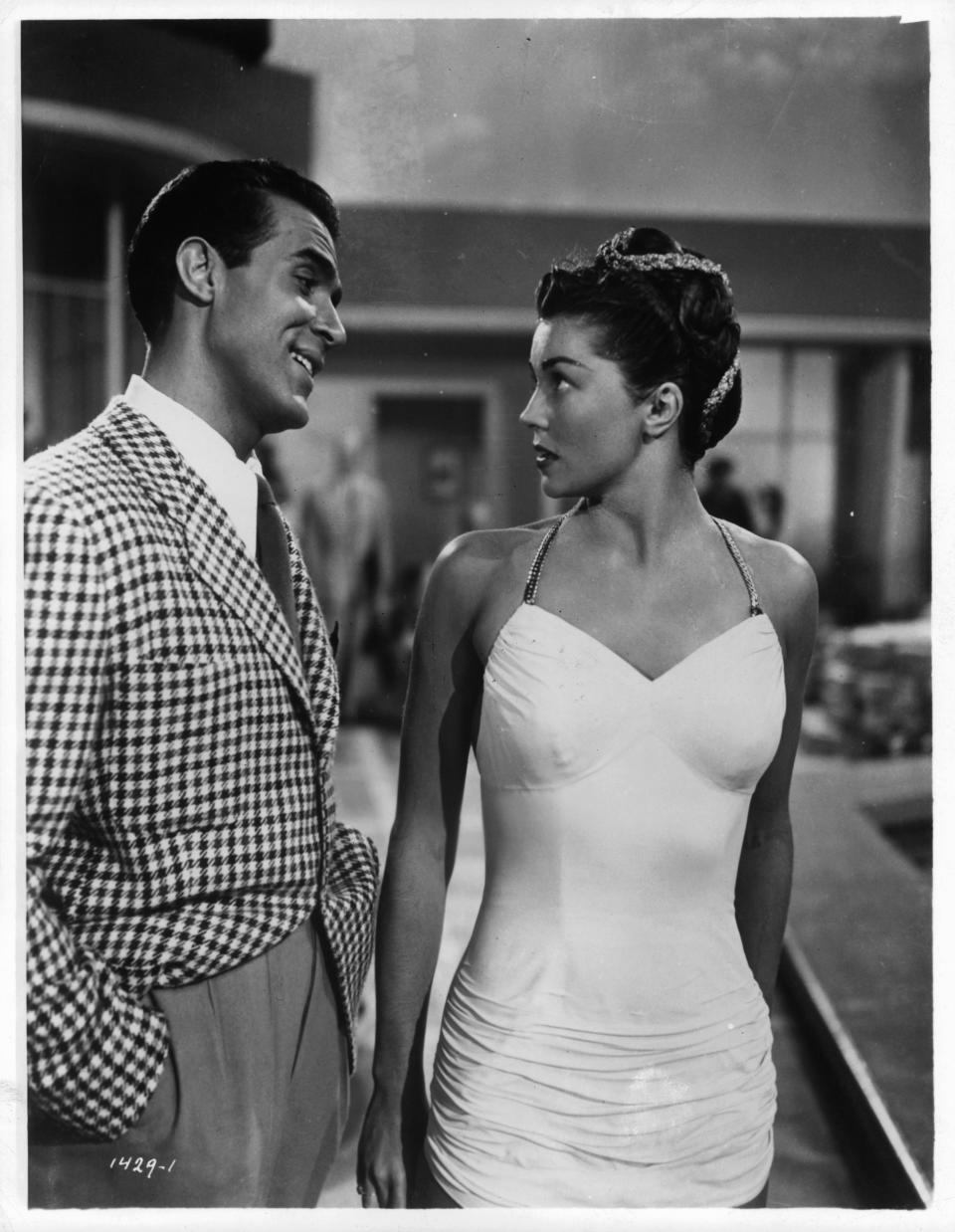 Ricardo Montalban smiling at swimsuit wearing Esther Williams in a scene from the film ‘Neptune’s Daughter’, 1949. (Photo by Metro-Goldwyn-Mayer/Getty Images)