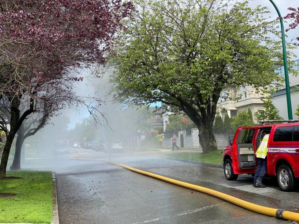 A severed fire hose is seen in Vancouver as firefighters respond to a house fire on May 28, 2022. (Maryse Ziedler/CBC - image credit)