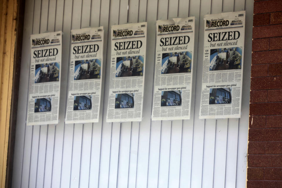 Front pages for the Marion County Record's latest weekly edition are displayed on a window at its offices, Monday, Aug. 21, 2023, in Marion, Kansas. Local police raided the newspaper's offices and home of its publisher, bringing the small central Kansas town to international attention. (AP Photo/John Hanna)