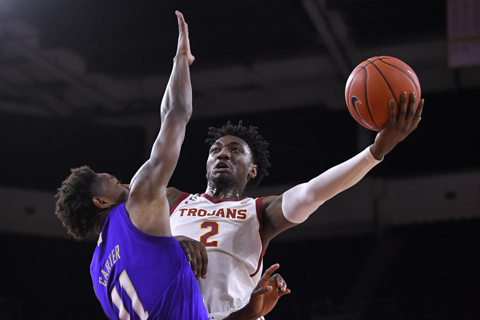 Southern California guard Jonah Mathews, right, shoots as Washington guard Nahziah Carter defends during the first half of an NCAA college basketball game Thursday, Feb. 13, 2020, in Los Angeles. (AP Photo/Mark J. Terrill)