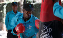 A Kenyan security guard participates in physical exercise during martial arts combat training at the Chinese-run Deway Security Group compound in Kenya's capital Nairobi, March 13, 2017. REUTERS/Thomas Mukoya