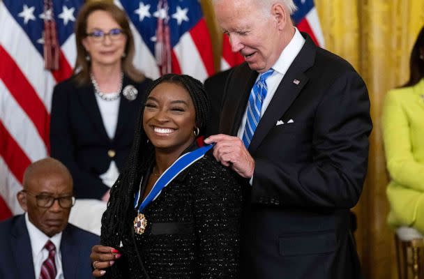 PHOTO: President Joe Biden presents Gymnast Simone Biles with the Presidential Medal of Freedom, the nation's highest civilian honor, during a ceremony honoring 17 recipients, in the East Room of the White House in Washington, D.C., July 7, 2022. (Saul Loeb/AFP via Getty Images)