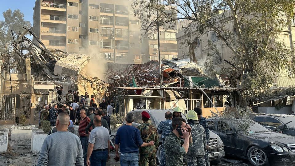 Emergency and security personnel gather at the site of strikes which hit a building next to the Iranian embassy in Syria's capital Damascus, on April 1, 2024. - Maher Al Mounes/AFP/Getty Images
