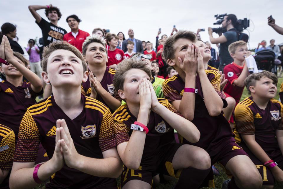 Children from the Massapequa youth soccer team wait for an announcement of host cities, at a 2026 FIFA World Cup host city selection watch party at Liberty State Park in Jersey City, N.J., Thursday, June 16, 2022. (AP Photo/Stefan Jeremiah)