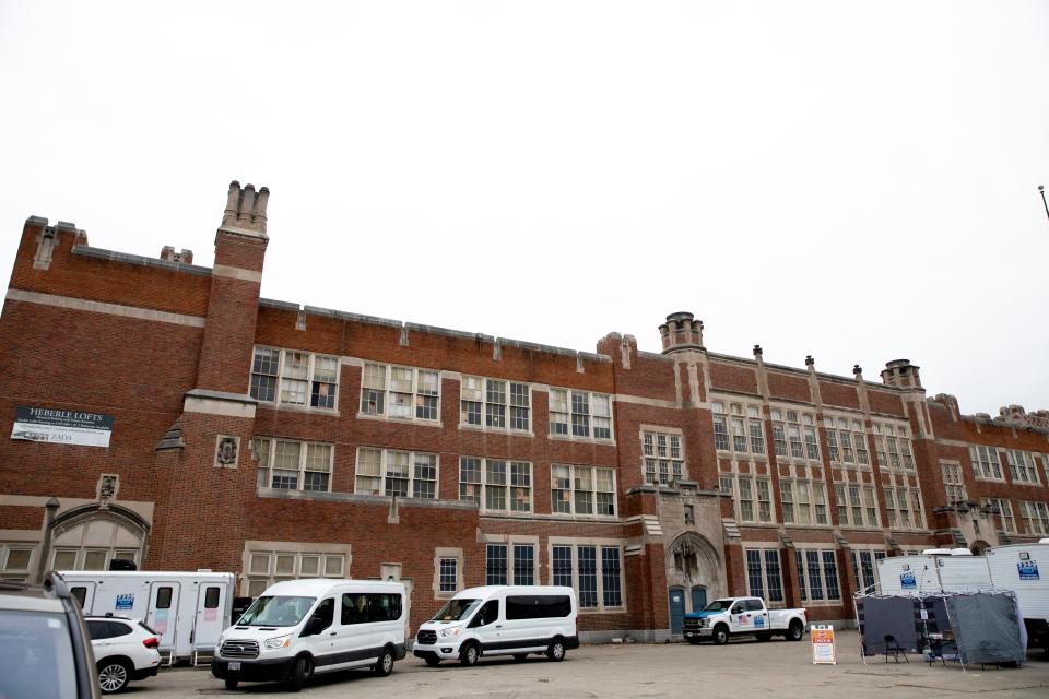 Film crews gather the old Herble Public School building to film a movie on Tuesday, Dec. 7, 2021 off Dayton Street in Cincinnati. Regina King is staring and is a producing the film, which tells the story of Shirley Chisholm, America’s first black congresswoman. “Shirley” is written and directed by Oscar-winning writer/director, John Ridley.