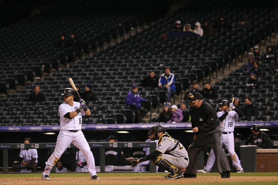 Gerardo Parra #8 of the Colorado Rockies takes an at bat in front of empty stands as catcher Francisco Cervelli #29 of the Pittsburgh Pirates backs up the plate and umpire Dale Scott oversees the action at Coors Field on April 26, 2016 in Denver, Colorado. The Pirates defeated Rockies 9-4. (Photo by Doug Pensinger/Getty Images)