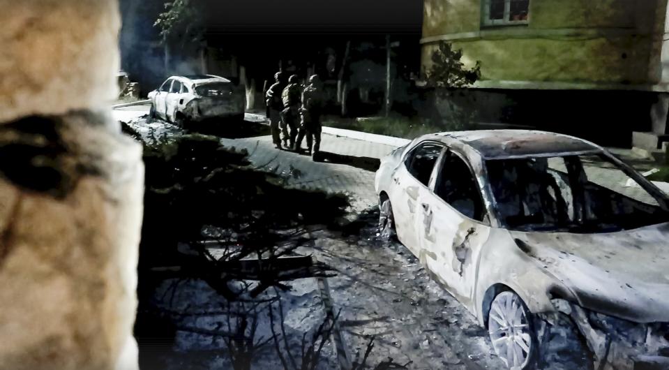 In this photo taken from video released by the National Antiterrorism Committee on Monday, June 24, 2024, FSB officers conduct a counter-terrorist operation in republic of Dagestan, Russia. Multiple police officers and several civilians, including an Orthodox priest, were killed by armed militants in Russia's southern republic of Dagestan on Sunday, its governor Sergei Melikov said in a video statement early Monday. (The National Antiterrorism Committee via AP)