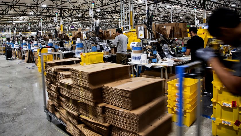 Workers quickly pack items on Cyber Monday at the Amazon Fulfillment Center on November 28, 2016 in San Bernardino, California.