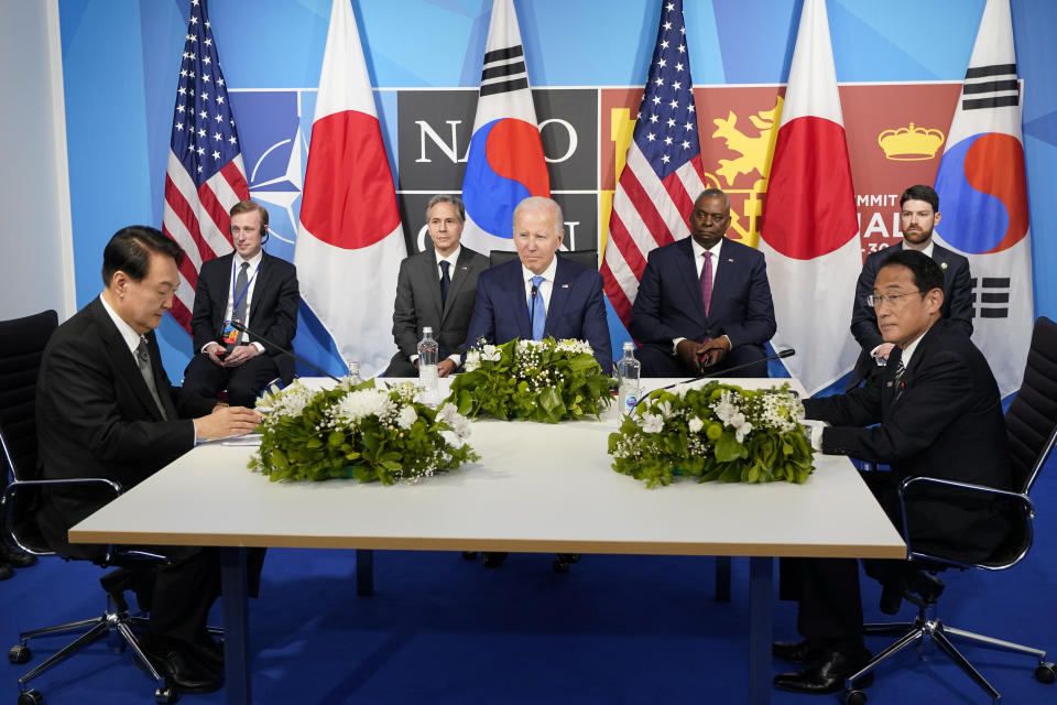 FILE - President Joe Biden, center, meets with South Korea's President Yoon Suk Yeol, left, and Japan's Prime Minister Fumio Kishida, right, during the NATO summit in Madrid, Wednesday, June 29, 2022. Biden aims to further tighten security and economic ties between Japan and South Korea, two nations that have struggled to stay on speaking terms, as he welcomes their leaders to the rustic Camp David presidential retreat Friday, Aug. 18, 2023. (AP Photo/Susan Walsh, File)