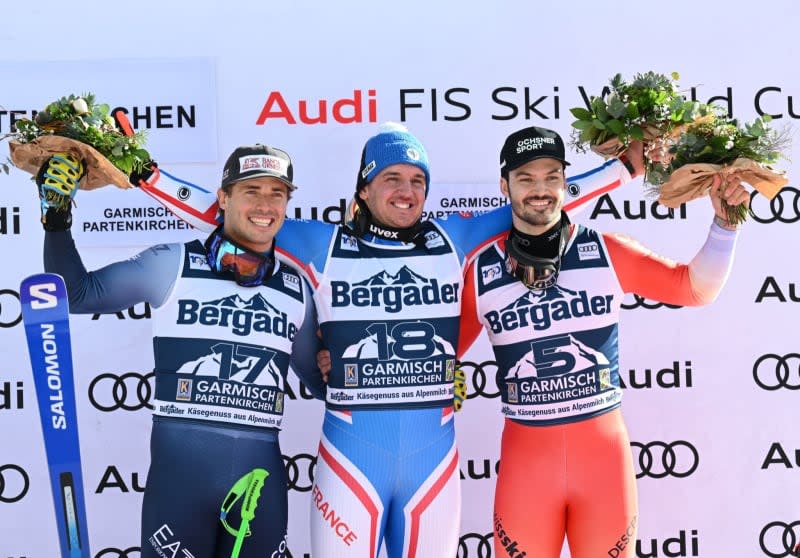 (L-R) Italy's second-placed Guglielmo Bosca, France's first-placed Nils Allegre and Switzerland's third-placed Loic Meillard celebrate on the podium after the men's Super-G race during the Alpine skiing World Cup in Garmisch-Partenkirchen. Angelika Warmuth/dpa