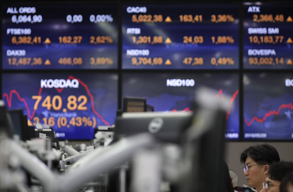 Currency traders watch computer monitors at the foreign exchange dealing room in Seoul, South Korea, Thursday, June 4, 2020. Asian stock markets are mixed after Wall Street rose on better U.S. jobs and manufacturing data than expected. (AP Photo/Lee Jin-man)