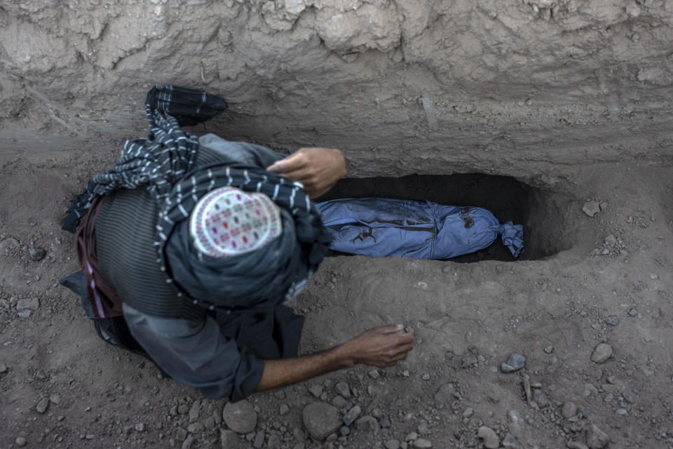 Un hombre entierra a su nieto, que murió en un potente sismo, en el distrito de Zenda Jan, en la provincia de Herat, Afganistán, el 9 de octubre de 2023. (AP Foto/Ebrahim Noroozi)