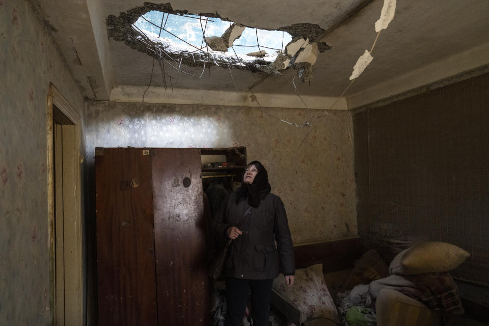 Halyna Falko looks at the destruction caused after a Russian attack inside her house near Brovary, on the outskirts of Kyiv, Ukraine, Monday, March 28, 2022. (AP Photo/Rodrigo Abd)