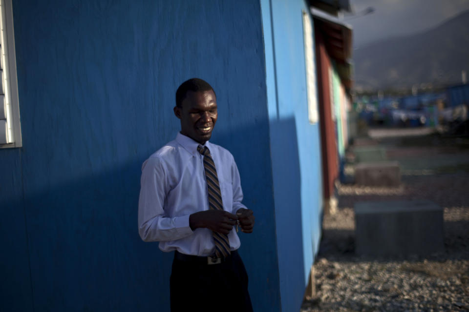 In this picture taken on Feb. 10, 2012, a blind man stands next to his blue-painted home at La Piste camp in Port-au-Prince, Haiti. While more than a million people displaced by the 2010 quake ended up in post-apocalyptic-like tent cities, some of the homeless disabled population landed in the near-model community of La Piste, a settlement of plywood shelters along tidy gravel lanes. However, the rare respite for the estimated 500-plus people living at the camp is coming to an end as the government moves to reclaim the land. (AP Photo/Ramon Espinosa)