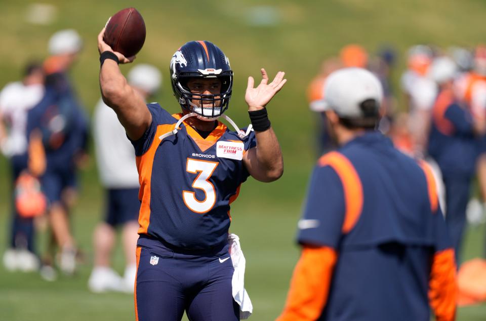 Denver Broncos quarterback Russell Wilson takes part in drills at the NFL football team's voluntary minicamp Wednesday, April 27, 2022, at the team's headquarters in Englewood, Colo. (AP Photo/David Zalubowski)