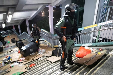 Riot police officers patrol during a protest at Tseung Kwan O district, in Hong Kong