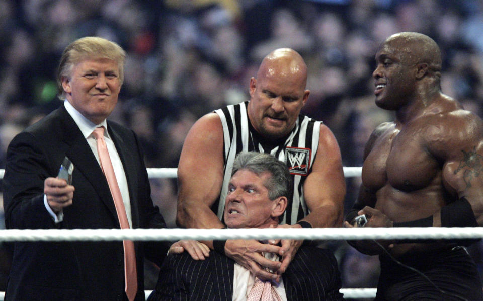 FILE - In this Sunday, April 1, 2007, file photo, WWE Chairman Vince McMahon, center, held by "Stone Cold" Steve Austin, prepares to have his hair cut off by Donald Trump, left, and Bobby Lashley, right, after Lashley defeated Umaga at Wrestlemania 23 at Ford Field in Detroit. Wrestling aficionados say President Trump, who has a long history with the game, has borrowed tactics of the sport to cultivate the ultimate antihero character - who wins at all costs, incites outrage and follows nobody's rules but his own. (AP Photo/Carlos Osorio, File)