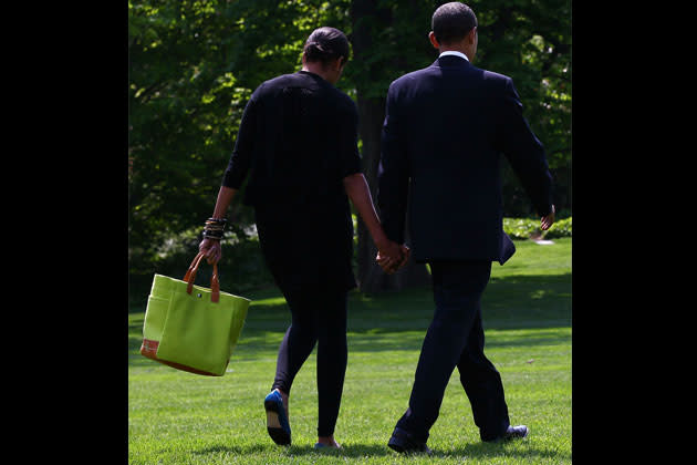 <b>April 2010</b> <br>With the President boarding Air Force One to go to North Carolina, bringing a punch of color with her Lamberston Treux tote.