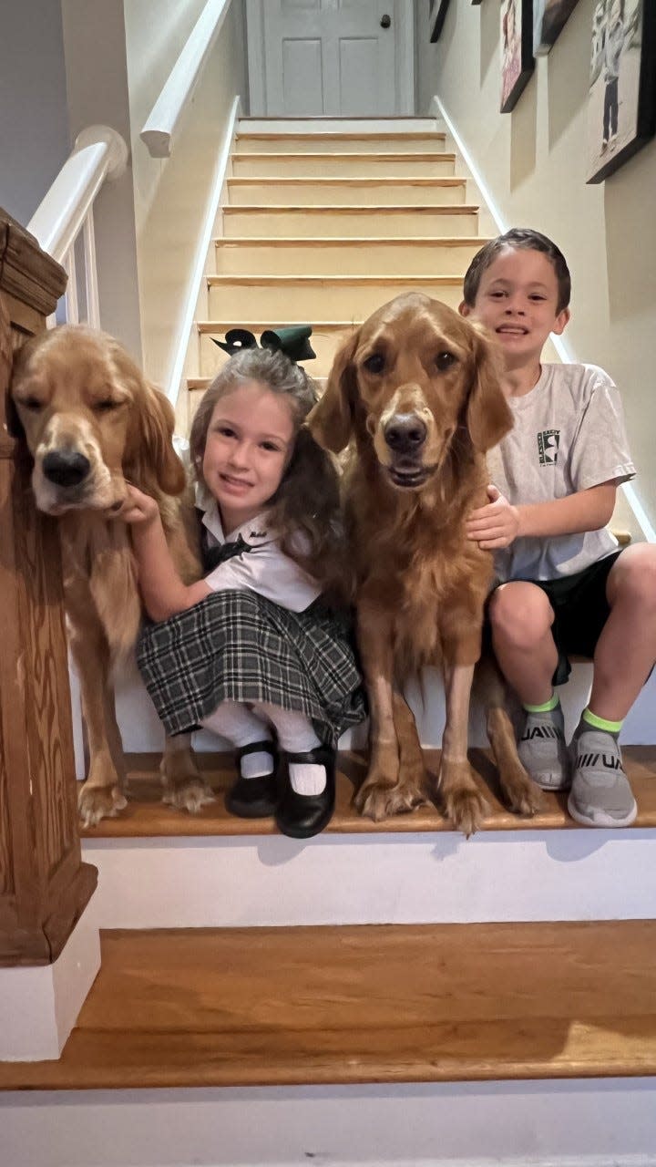 Charlotte and Hudson with the dogs, Palmer and Finley.