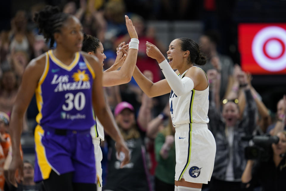 Minnesota Lynx forward Napheesa Collier, right, celebrates their win against the Los Angeles Sparks after a WNBA basketball game Sunday, June 11, 2023, in Minneapolis. (AP Photo/Abbie Parr)