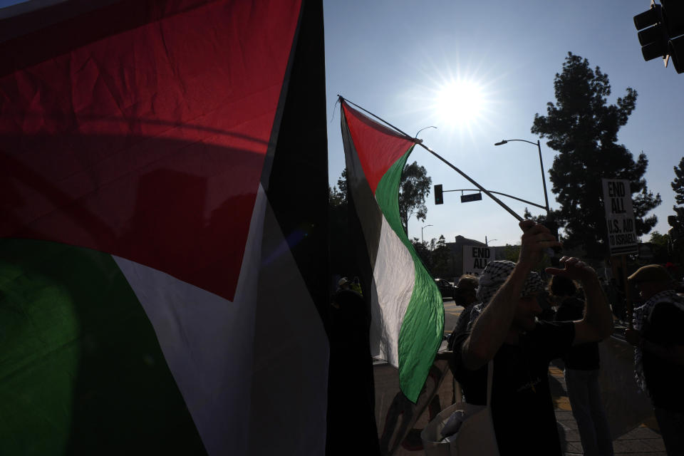Pro-Palestinian demonstrators rally at the Shrine Auditorium, where a commencement ceremony for graduates from Pomona College was being held Sunday, May 12, 2024, in Los Angeles. (AP Photo/Ryan Sun)