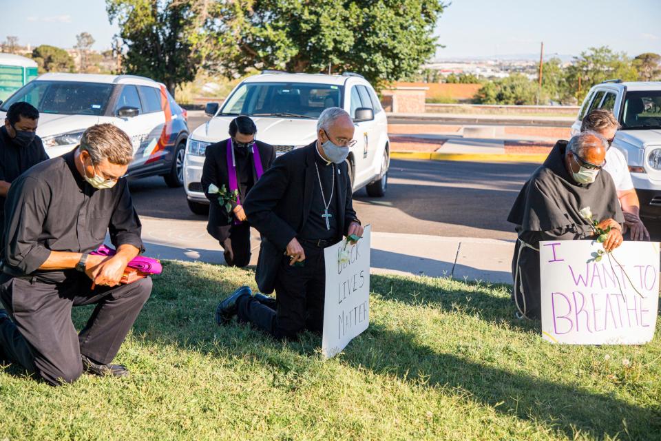 Bishop Seitz and other Catholic clergy take the knee during a Black Lives Matter rally in Memorial Park, on June 1, 2020.