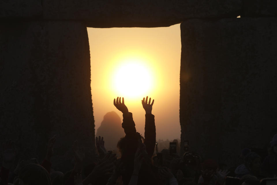 Revelers gather at the ancient stone circle Stonehenge to celebrate the Summer Solstice, the longest day of the year, near Salisbury, England, Wednesday, June 21, 2023. (AP Photo/Kin Cheung)