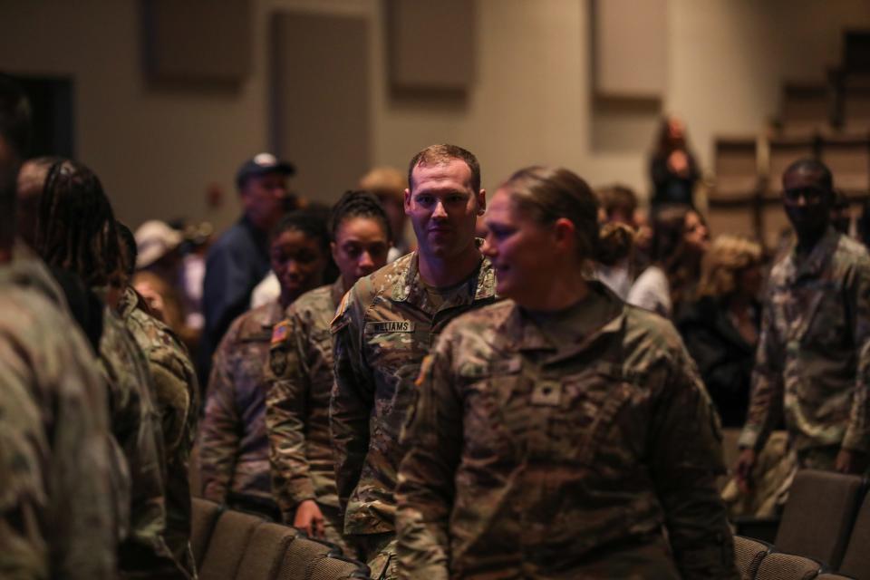 Alabama National Guardsmen in the 135th Expeditionary Sustainment Command approach their seats during their welcome home ceremony in Birmingham, Ala., January 14, 2023. These same soldiers will be released to be with their families after a deployment to Kuwait within the hour.
