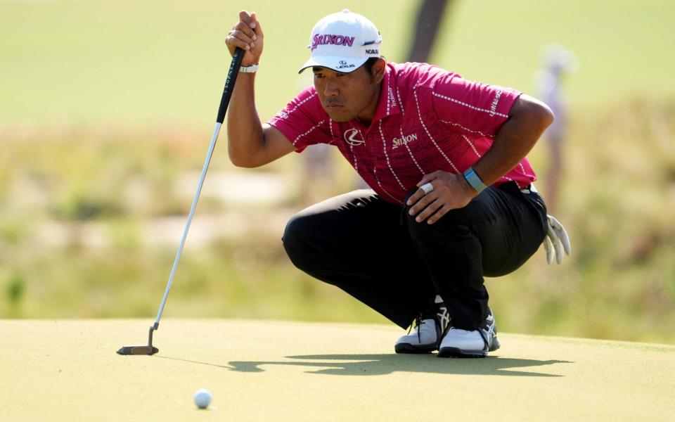 Hideki Matsuyama lines up a putt on the 13th hole