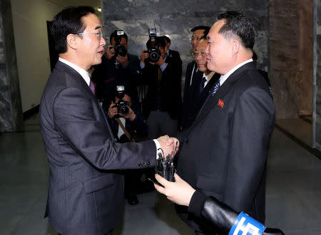 South Korean Unification Minister Cho Myoung-gyon is greeted by his North Korean counterpart Ri Son Gwon as he arrives for their meeting at the truce village of Panmunjom, North Korea, March 29, 2018. Korea Pool/Yonhap via REUTERS