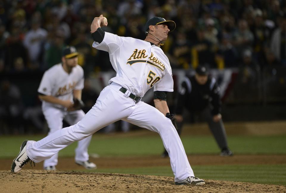 Grant Balfour #50 of the Oakland Athletics pitches in the ninth inning against the Detroit Tigers during Game Three of the American League Division Series at Oakland-Alameda County Coliseum on October 9, 2012 in Oakland, California. The Athletics won the game 2-0. (Photo by Thearon W. Henderson/Getty Images)