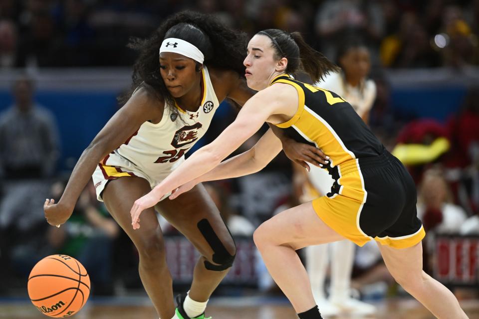 South Carolina guard Raven Johnson (25) steals the ball from Iowa guard Caitlin Clark (22) during the championship game of the 2024 NCAA women's tournament at Rocket Mortgage FieldHouse.