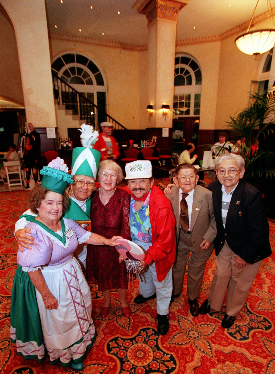 In this Oct. 30, 1997 file photo, cast members of the Munchkins from "The Wizard of Oz," from left, Margaret Pellegrini, Clarence Swensen, Ruth Duccini, Jerry Maren, Karl Slover, and Mickey Carroll pose in The Culver Hotel, in Culver City, Calif., where they stayed during the filming of the famed movie. Ruth Robinson Duccini, one of the original Munchkins from the 1939 legendary movie, has died, Thursday, Jan. 16, 2014. She was 95. (AP Photo/Mark J. Terrill, File)