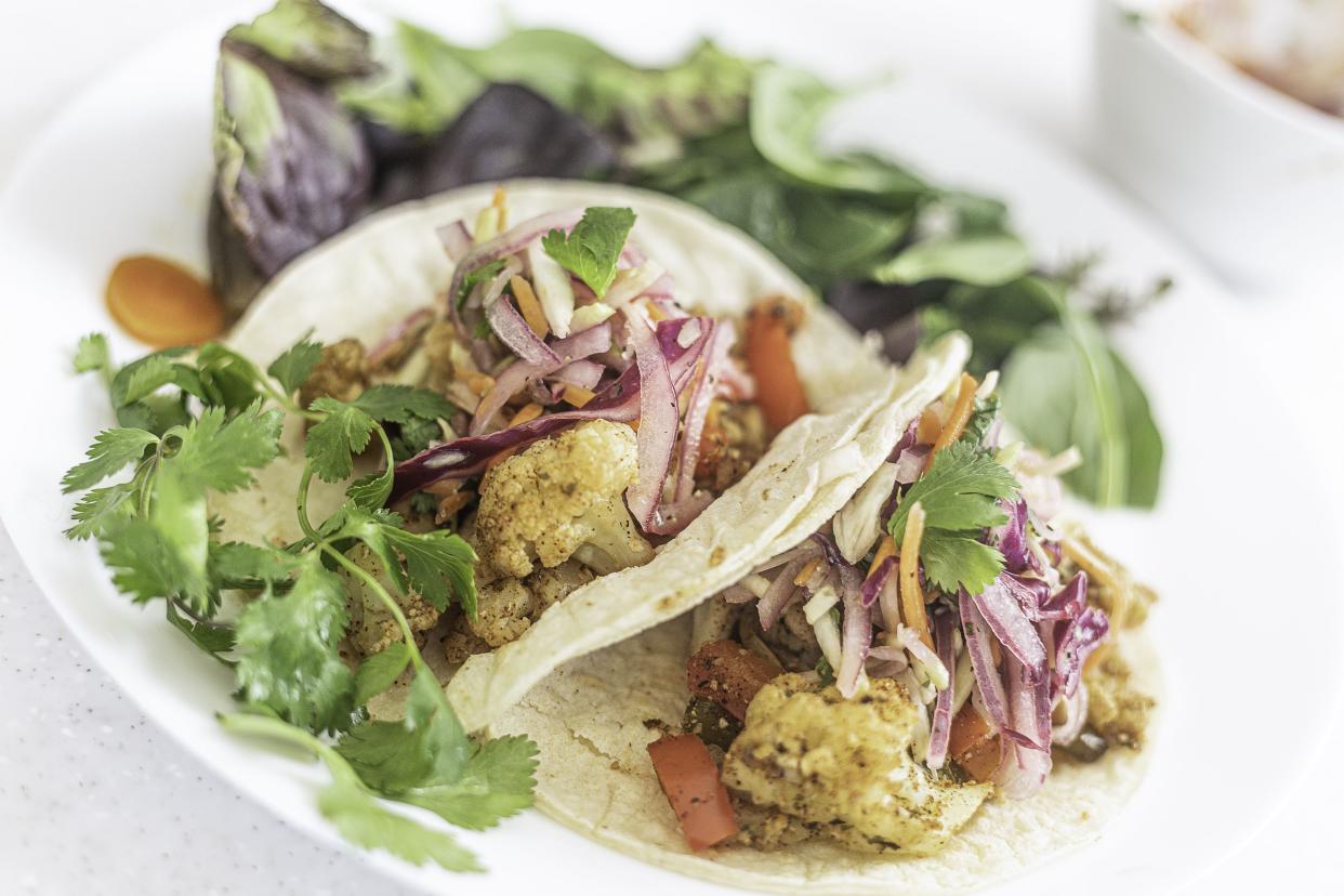 Plant-Based Cauliflower Tacos on gluten free Soft Corn Tortillas with salad and cilantro lime slaw