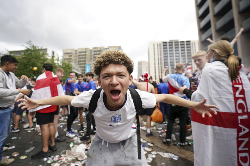 An England fan reacts as crowds gather outside the ground, ahead of the Euro 2020 soccer championship final match between England and Italy, at Wembley Stadium, in London, Sunday, July 11, 2021. (Zac Goodwin/PA via AP)