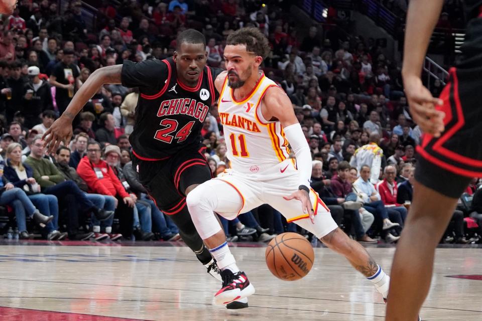 Apr 17, 2024; Chicago, Illinois, USA; Chicago Bulls guard Javonte Green (24) defends Atlanta Hawks guard Trae Young (11) during the second half during a play-in game of the 2024 NBA playoffs at United Center. Mandatory Credit: David Banks-USA TODAY Sports