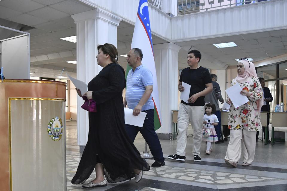 Voters walk to cast their ballots at a polling station during a referendum in Tashkent, Uzbekistan, Sunday, April 30, 2023. Voters in Uzbekistan are casting ballots in a referendum on a revised constitution that promises human rights reforms. But the reforms being voted on Sunday also would allow the country's president to stay in office until 2040. (AP Photo)