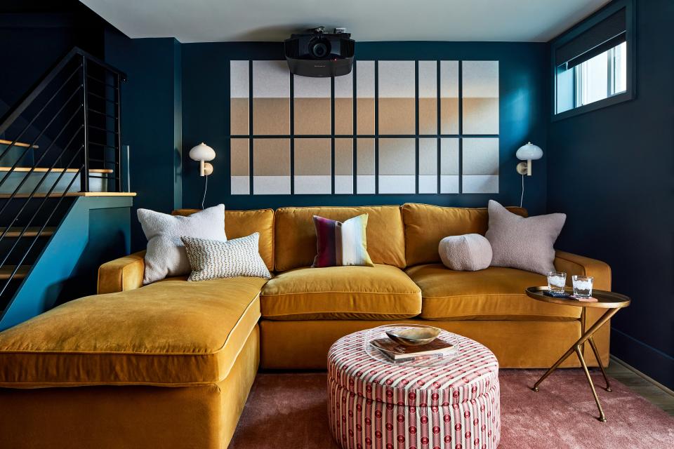 The basement lounge pops in jewel tones, thanks to a James sectional from Interior Define, a blush pink Akara Rugs carpet, and a Quinn large storage ottoman by Joy Bird that wears Pierre Frey’s Rochambeau fabric. Araceli brass side tables by Lulu and Georgia give the room a glam spin.