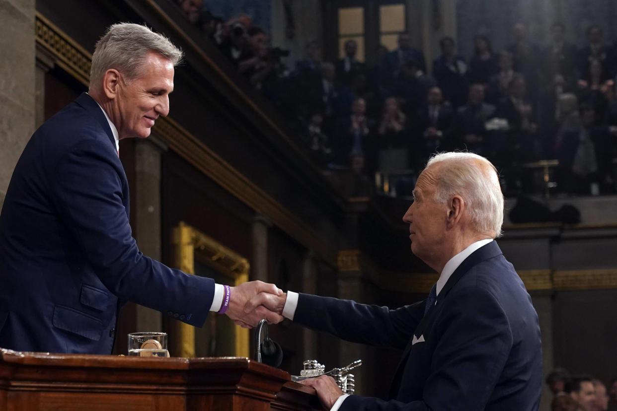 Kevin McCarthy and Biden shake hands.