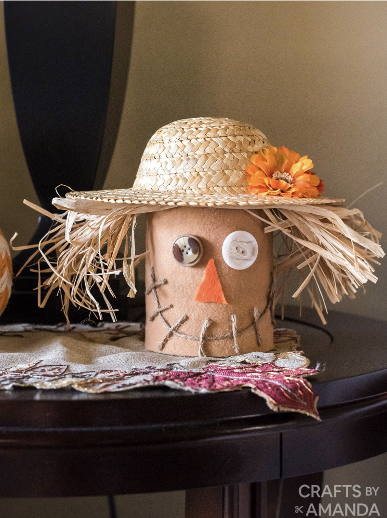 thanksgiving crafts coffee can decorated with a straw hat to look like a scarecrow