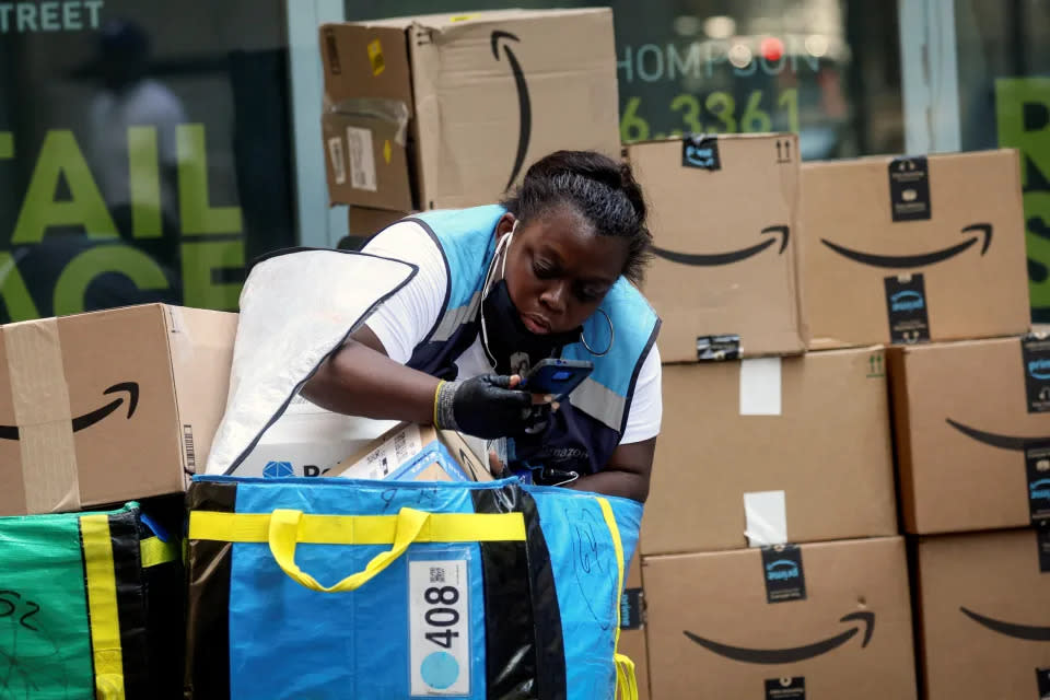 An Amazon delivery worker checks packages in New York City, United States, July 11, 2022. REUTERS/Brendan McDermid
