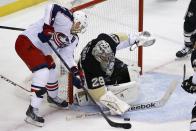 Columbus Blue Jackets' Brandon Dubinsky, left, can't get a shot past Pittsburgh Penguins goalie Marc-Andre Fleury (29) diuring the first period of a first-round NHL playoff hockey game in Pittsburgh on Wednesday, April 16, 2014.(AP Photo/Gene J. Puskar)