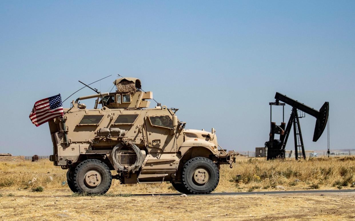 A US military vehicle patrols near the Rumaylan (Rmeilan) oil fields in Syria's Kurdish-controlled northeastern Hasakeh province - AFP