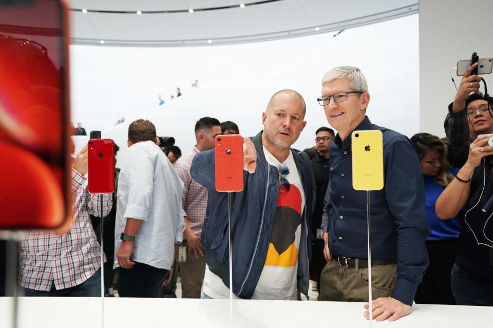 Apple executives Tim Cook and Jony Ive looking at the iPhone XR.