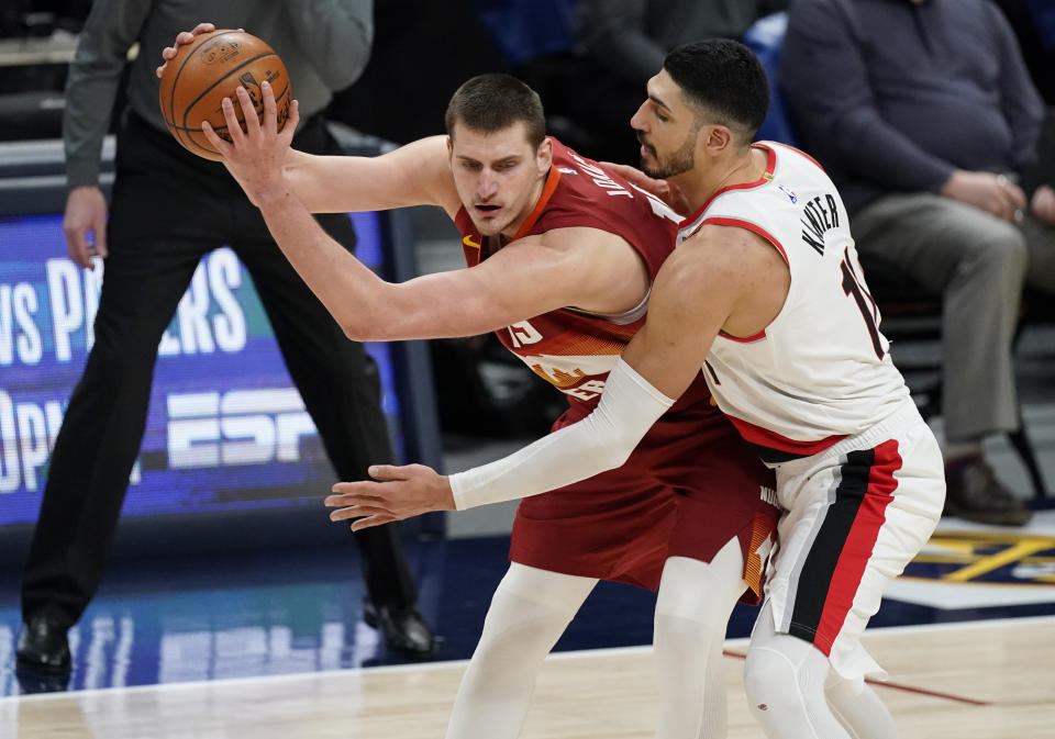 Denver Nuggets center Nikola Jokic, left, is defended by Portland Trail Blazers center Enes Kanter during the second half of an NBA basketball game on Tuesday, Feb. 23, 2021, in Denver. (AP Photo/David Zalubowski)