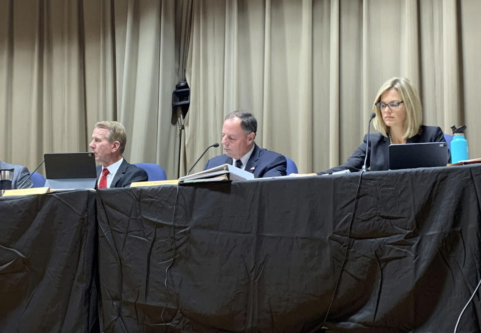 A hearing held by North Dakota regulators on a proposed expansion of the Dakota Access pipeline drew a large crowd to the Emmons County Courthouse in Linton, North Dakota on Wednesday, Nov. 13, 2019. Left to right: North Dakota Public Service Commissioners chairman Brian Kroshus, Randy Christmann and Julie Fedorchak. (Amy Sisk/The Bismarck Tribune via AP)