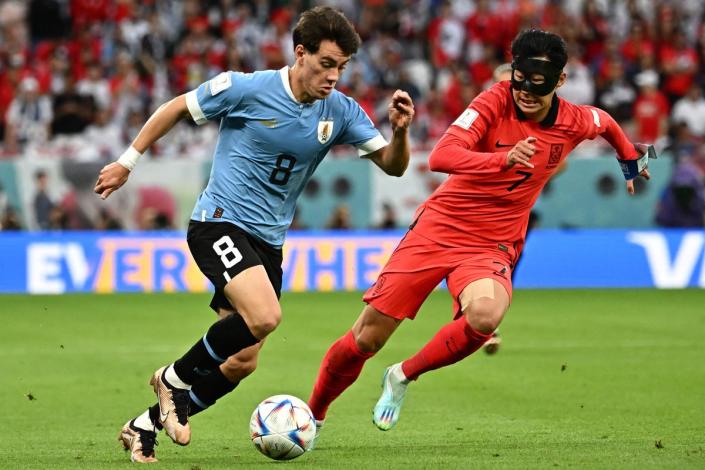 Facundo Pellistri runs with the ball past South Korean midfielder Son Heung-min (AFP via Getty Images)