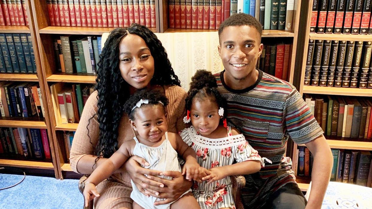 Iesha Harper and Dravon Ames pose with their daughters.