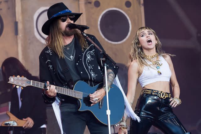 <p>Ian Gavan/Getty</p> Billy Ray Cyrus and Miley Cyrus perform on the Pyramid stage on day five of Glastonbury Festival at Worthy Farm, Pilton in June 2019 in Glastonbury, England